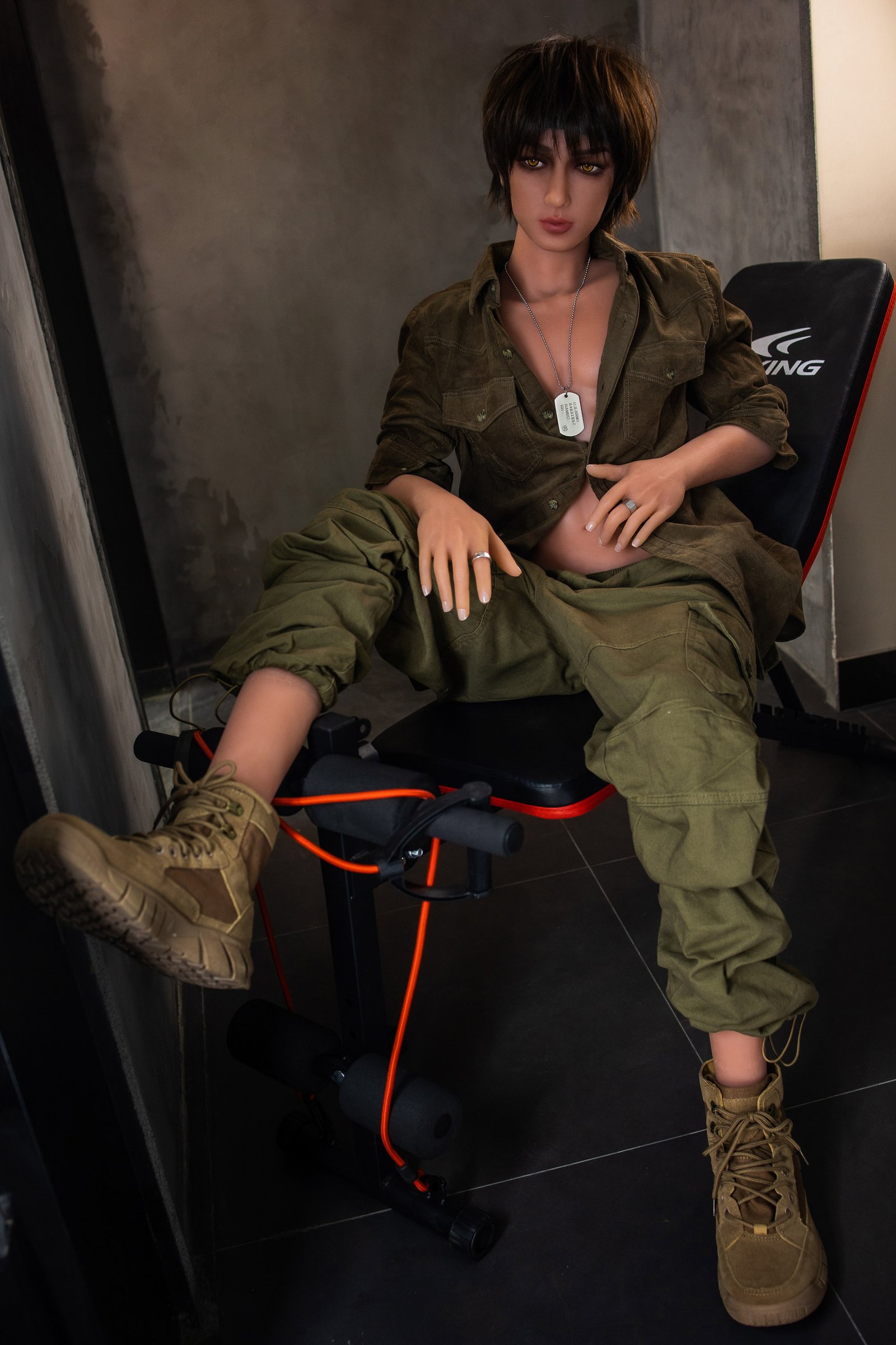 Male doll seated in a black gaming chair wearing green cargo clothing